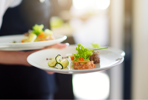 Plated food being served at an event