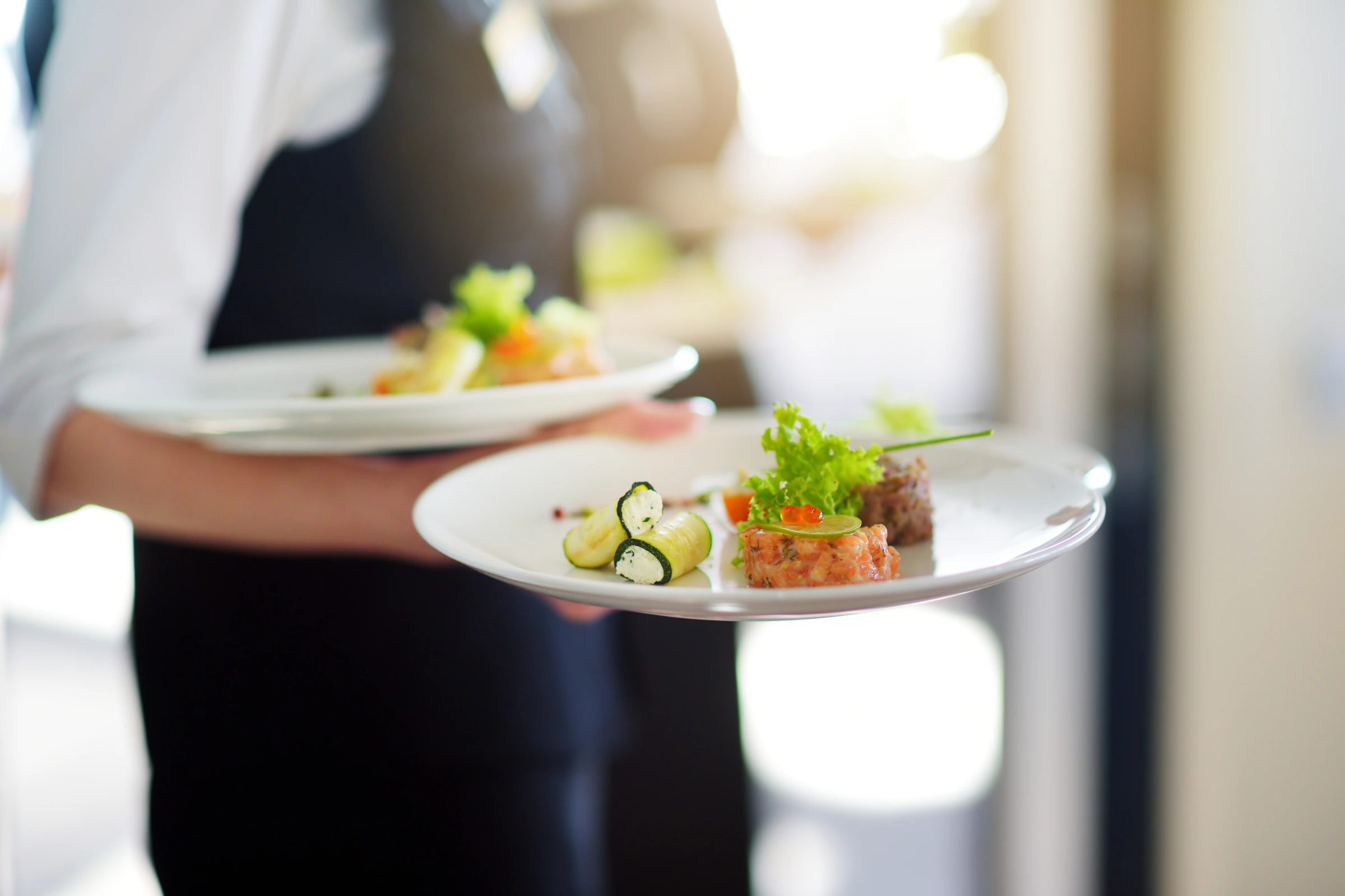 Ruffles catering team presenting plated food